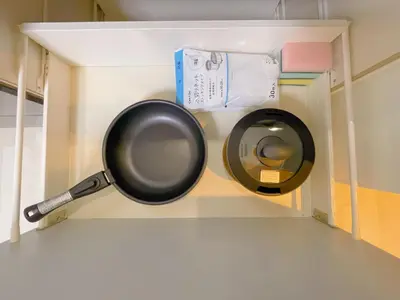 a frying pan hanging on a wall in a kitchen at Sakura Stay \u5343\u99c4\u6728 in Tokyo