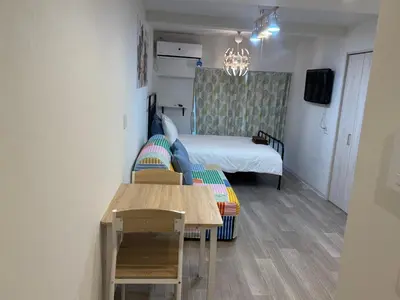 a small room with a bed and a table at 5minutes from Shinjuku Shin-Okubo Station-k203 in Tokyo