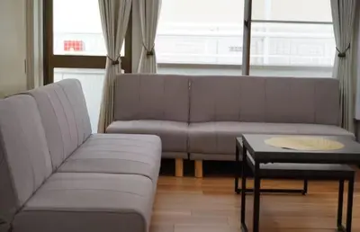 a living room with a couch and a coffee table at nagumobiru202 in Tokyo
