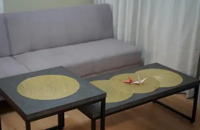 a living room with two tables and a couch at nagumobiru202 in Tokyo
