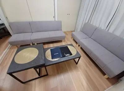 a living room with a couch and a table at nagumobiru202 in Tokyo