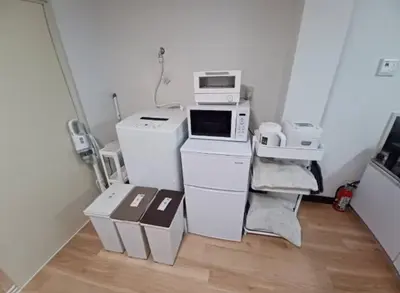 a room filled with white appliances and boxes at nagumobiru202 in Tokyo