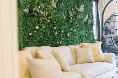 a white couch with pillows in front of a green wall at Penthouse, 8min walk to Shibuya Sta in Tokyo