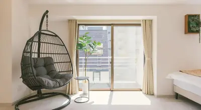 a swinging chair in a bedroom with a window at Penthouse, 8min walk to Shibuya Sta in Tokyo