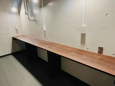a long wooden counter in a locker room at Meguro Midori Hotel in Tokyo