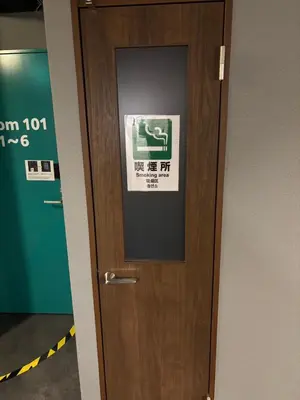 a door in a room with a sign on it at Meguro Midori Hotel in Tokyo