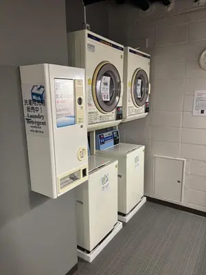 a laundry room with machines on display in a building at Meguro Midori Hotel in Tokyo
