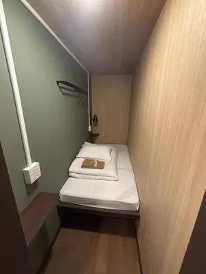 a small room with a bed in a small room at Meguro Midori Hotel in Tokyo