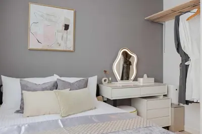 a bedroom with a bed and a dresser and a mirror at Hotel-Like Simmons Bed Couple Disney Shinjuku in Tokyo