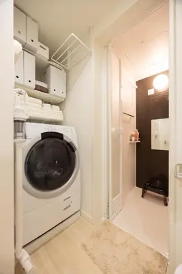 a laundry room with a washer and dryer at Hotel-Like Simmons Bed Couple Disney Shinjuku in Tokyo