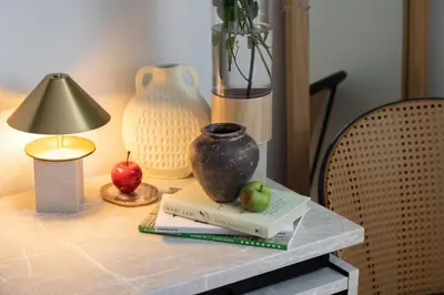 a table with a vase and an apple on a book at Hotel-Like Simmons Bed Couple Disney Shinjuku in Tokyo