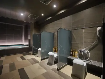 a bathroom with two urinals and a bath tub at Premium hotel MONday MAIHAMA View 1 in Tokyo