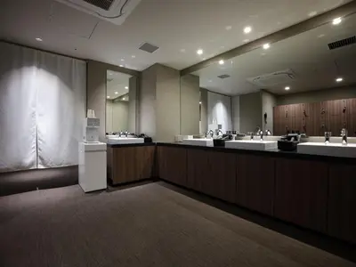 a large bathroom with three sinks and a large mirror at Premium hotel MONday MAIHAMA View 1 in Tokyo
