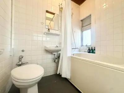 a white bathroom with a toilet and a sink at \u6c5f\u5143\u6d45\u8349\u6c11\u6cca in Tokyo
