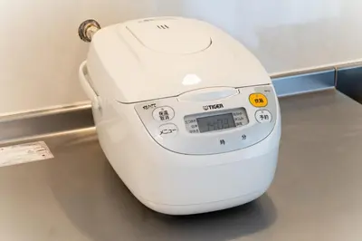a white hair dryer sitting on a floor at Private Apartment HOTEL Ceres Kamiikebukuro 301 in Tokyo