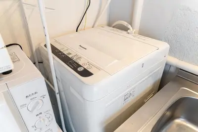 a washer and dryer sitting next to a washing machine at Private Apartment HOTEL Ceres Kamiikebukuro 301 in Tokyo