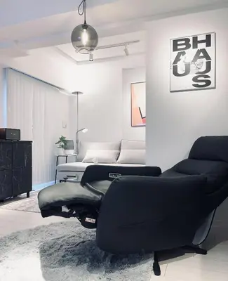 a bedroom with a black couch and a bed at Alo BnB 11 - Near Roppongi, Ginza, Shinjuku, Shibuya - Self check-in in Tokyo