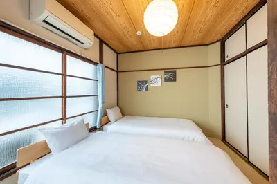 two beds in a room with two windows at Higashi-Ueno 3 in Tokyo