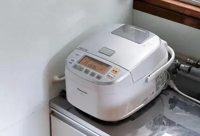 a white machine sitting on top of a washing machine at Higashi-Ueno 3 in Tokyo