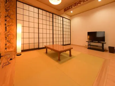 a room with a table and a flat screen tv at Sumida Tatekawa House in Tokyo
