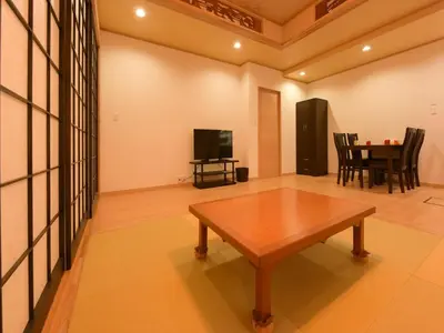 a living room with a table and a tv at Sumida Tatekawa House in Tokyo