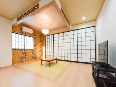 a large room with a bench in the middle at Sumida Tatekawa House in Tokyo