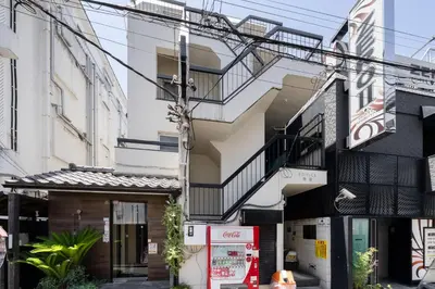 a building with a gas station in front of it at Fuufu House Tokyo SHIBUYA - No Elevator 4F WalkUp in Tokyo