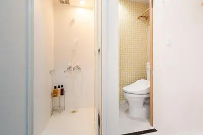 a small bathroom with a toilet and a shower at Fuufu House Tokyo SHIBUYA - No Elevator 4F WalkUp in Tokyo