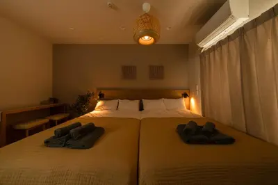 a bedroom with two beds with towels on them at Fuufu House Tokyo SHIBUYA - No Elevator 4F WalkUp in Tokyo