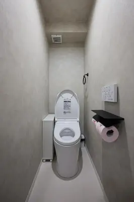 a small bathroom with a toilet with the lid up at The Gallery Stay Monnaka in Tokyo