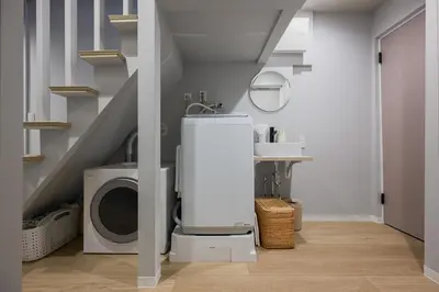 a laundry room with a washing machine and a washer and dryer at The Gallery Stay Monnaka in Tokyo