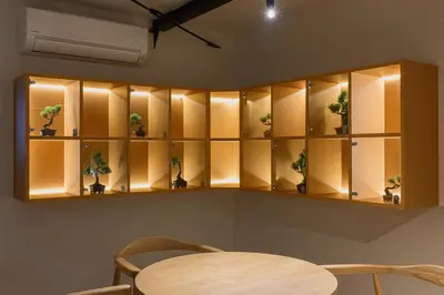 a room with shelves with potted plants in them at The Gallery Stay Monnaka in Tokyo