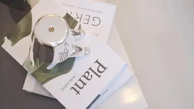 a silver watch sitting on top of a paper at Liotta SHINBASHI A 7 beds, 7-minute walk from Shimbashi, up to 11 people in Tokyo