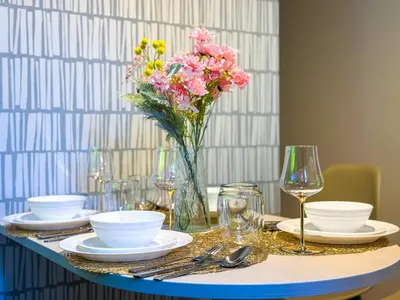 a table with plates and a vase of flowers on it at Hotel-Mercurius-ShinOkubo-SBJB3F in Tokyo