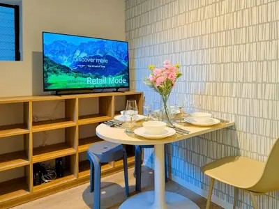 a room with a table with a tv and flowers on it at Hotel-Mercurius-ShinOkubo-SBJB3F in Tokyo