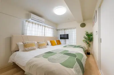 a bedroom with a large bed in a room at \u304b\u3064\u3089201 in Tokyo