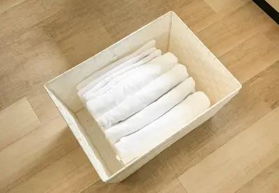 a box of towels sitting on a wooden floor at \u304b\u3064\u3089201 in Tokyo
