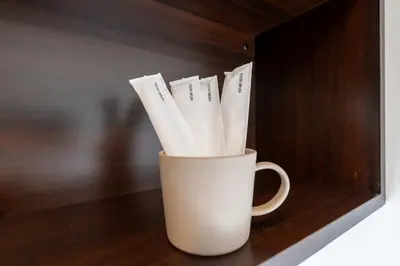 a white cup filled with white paper straws at LIVCITY Kinshicho 201 in Tokyo