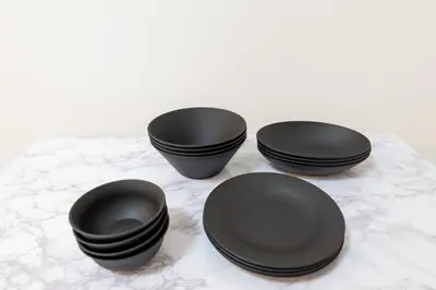 three black plates sitting on a table at LIVCITY Kinshicho 201 in Tokyo