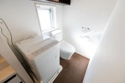 a small kitchen with a white refrigerator and a toilet at LIVCITY Kinshicho 202 in Tokyo