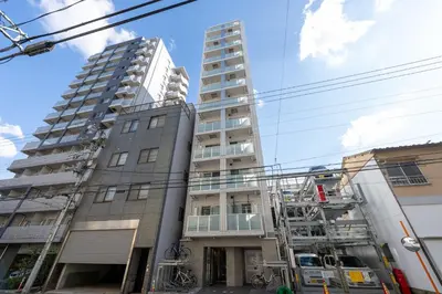 a tall apartment building with two tall buildings at LIVCITY Kinshicho 702 in Tokyo