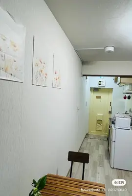 a room with a white wall with paintings on it at Tokyo Maneki Stay Gotokuji in Tokyo