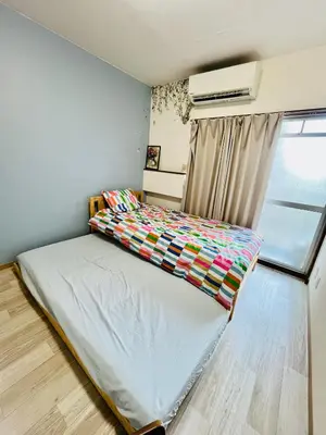 a small bedroom with a bed with a window at Tokyo Maneki Stay Gotokuji in Tokyo