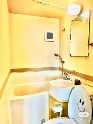 a small bathroom with a toilet and a sink at Tokyo Maneki Stay Gotokuji in Tokyo