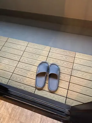 a pair of shoes sitting on a tiled floor at Shitamachi Shin-Koiwa 201 in Tokyo