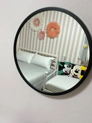 a mirror reflecting a bedroom with a bed and pillows at Shitamachi Shin-Koiwa 201 in Tokyo