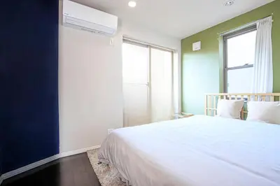 a bedroom with a white bed and a window at DM Hotel in Tokyo