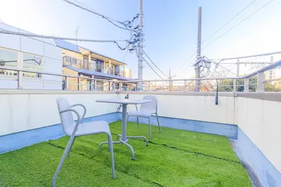 a table and two chairs on a roof at DM Hotel in Tokyo