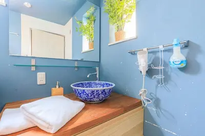 a bathroom with a bowl sink on a wooden counter at DM Hotel in Tokyo