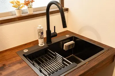 a sink in a kitchen with a faucet at \u548c\u6c23\u4f1a\u3005\u5357\u9577\u5d0e Wakiaiai Minaminagasaki in Tokyo